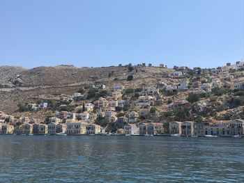 Townscape by sea against clear sky