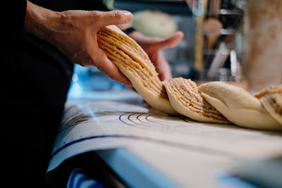 Close-up of hand holding cake dough