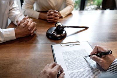 Midsection of lawyer working at table