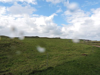 Scenic view of landscape against cloudy sky