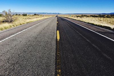 Road on field against clear sky