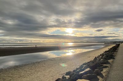 Scenic view of beach against sky during sunset