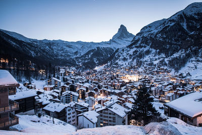 High angle view of snow covered houses against sky