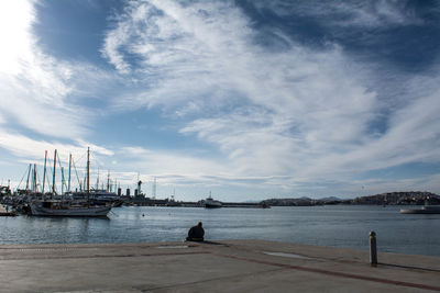 Harbor against cloudy sky