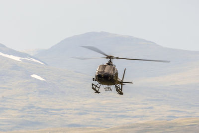 Helicopter flying in the wilderness