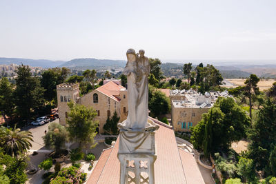 High angle view of statue against buildings in city