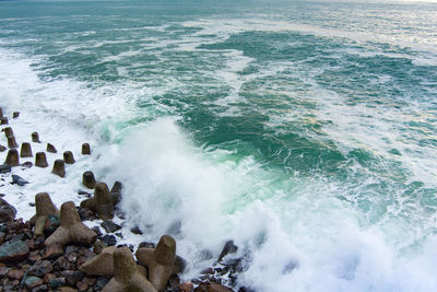 View of waves breaking on rocks