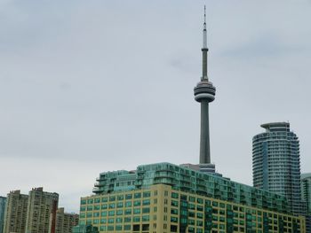Low angle view of cn tower and buildings against sky