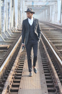 Full length of man walking on railroad track