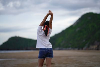 Rear view of girl standing on beach