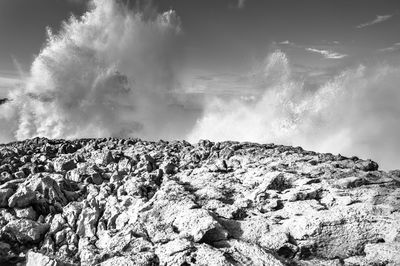 Scenic view of rocks in sea against sky