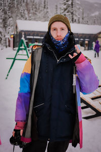 Rear view of woman standing against snow