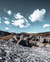 Surface level of rocks against sky