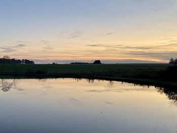 Scenic view of lake against sky during sunset