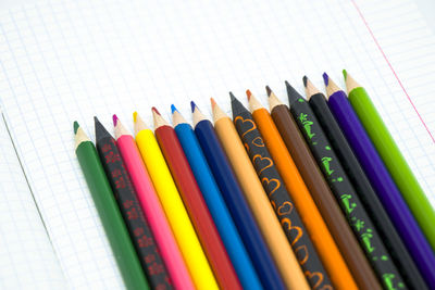 Close-up of colored pencils against white background