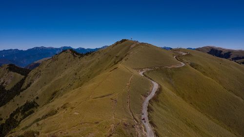 Scenic view of mountains against clear blue sky