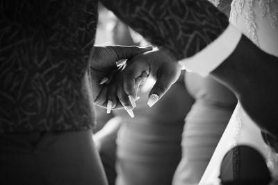 Couple holding hands while reading vows their wedding