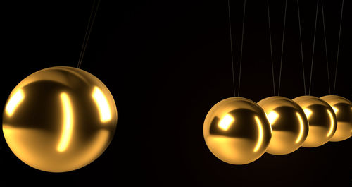 Close-up of illuminated lighting equipment against black background