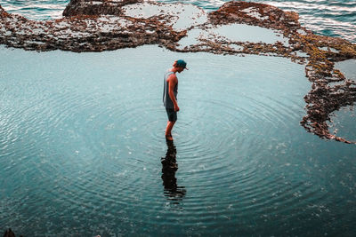 High angle view of man standing in sea