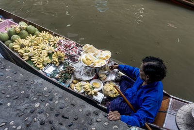 High angle view of woman selling fruits in boat