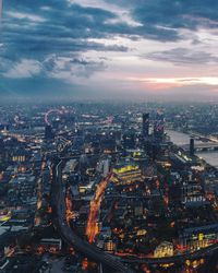 High angle view of illuminated cityscape against sky at dusk