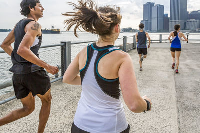 Group of runners training on waterfront in brooklyn bridge park
