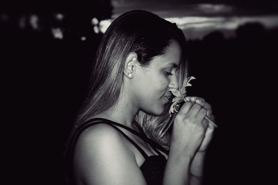 Woman smelling flower