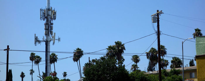 Low angle view of electricity pylon against clear sky