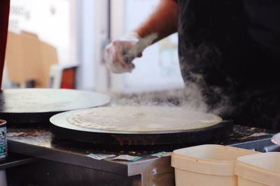 Close-up of man preparing food in kitchen