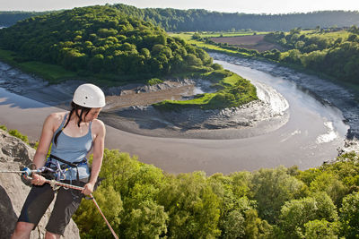 Woman rappelling of cliff in south wales