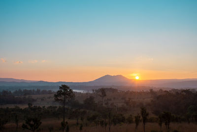 Scenic view of silhouette mountains against sky during sunset