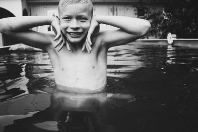 Portrait of shirtless man swimming in pool