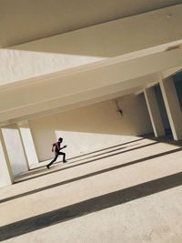 Low angle view of woman walking on building