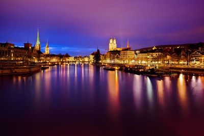 Reflection of illuminated buildings in city at night