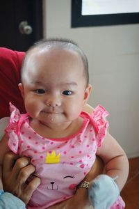 Portrait of cute baby girl at home