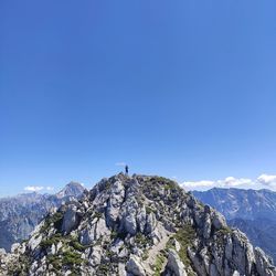 Scenic view of snowcapped mountains against clear blue sky