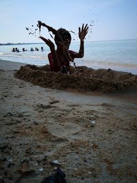 People on beach against sky