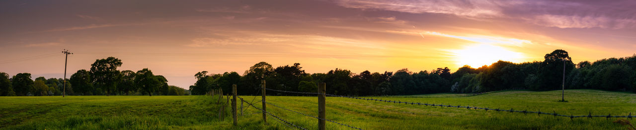 Scenic view of field against sky during sunset