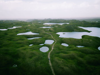 Scenic view of lake amidst landscape against sky