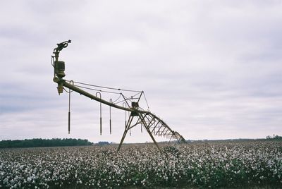 Windmill on field against sky