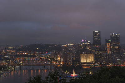 High angle view of city lit up at night