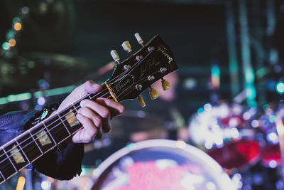 Close-up of man playing guitar