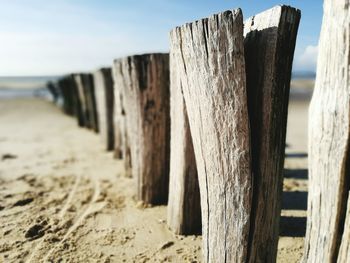 Close-up of wooden fence on beach