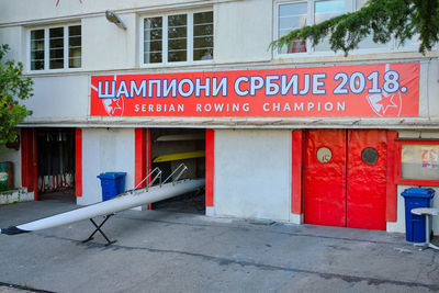 Information sign on street against buildings in city