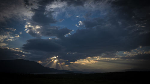 Scenic view of silhouette mountains against sky during sunset