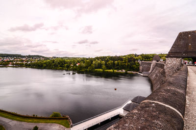 Scenic view of river against cloudy sky