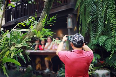 Side view of woman looking through binoculars