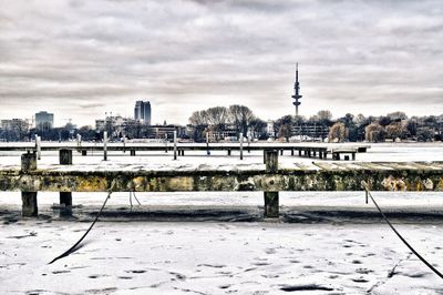 Snow covered city against sky