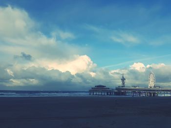 View of beach against cloudy sky