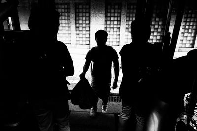 Silhouette people standing in corridor